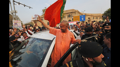 Chief Minister of India's Uttar Pradesh state Yogi Adityanath waves to supporters as he arrives at the Bharatiya Janata Party headquarters after his party won the state assembly election, in Lucknow, Thursday. (AP)