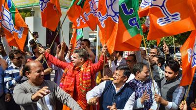 J&K BJP chief Ravinder Raina along with party workers celebrates the party's victory in the assembly elections, in Jammu on Thursday. (PTI)