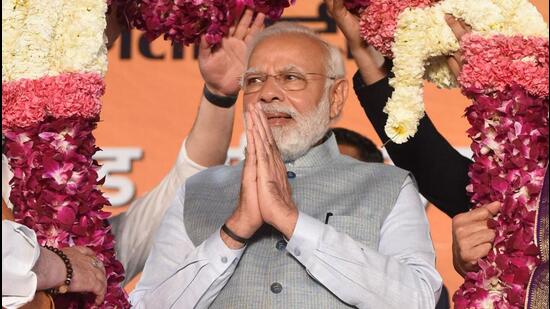 Prime Minister Narendra Modi being garlanded by BJP leaders following the party's win in the Uttar Pradesh assembly election in New Delhi on Thursday. (PTI)