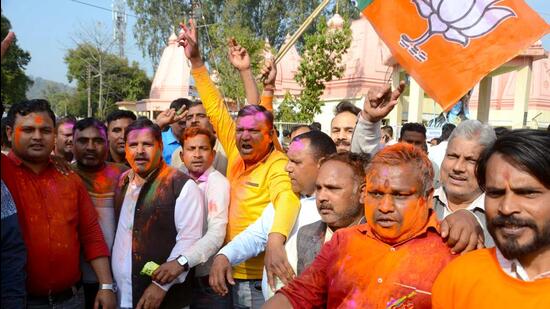 BJP supporters celebrate the party's lead in Uttarakhand assembly elections, in Haridwar on Thursday. (ANI)