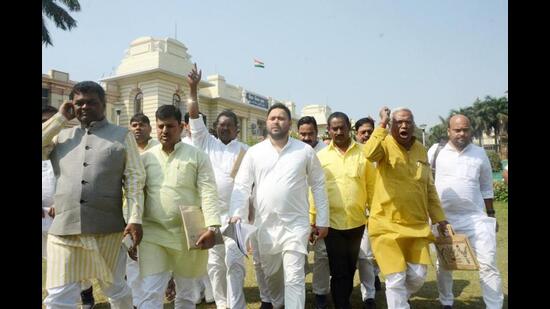 RJD leader Tejashwi Yadav along with party legislators outside the Bihar assembly on Thursday. (Santosh Kumar/HT Photo)