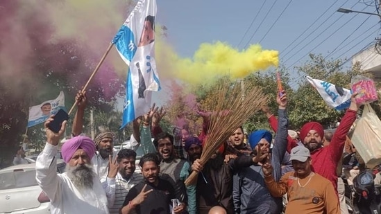 AAP workers celebrate outside the residence of Kunwar Vijay Pratap Singh in Amritsar.