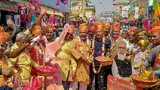 BJP supporters celebrate with flowers, as the party heads to a landslide victory in the UP Assembly elections, in Varanasi on March 10, 2022.&nbsp;(PTI)