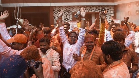 Bharatiya Janata Party (BJP) workers and supporters have started with the celebrations in Lucknow as trends favour the party. If the early leads sustain, the BJP may be on the way to retaining power in the state.(HT Photo/Deepak Gupta)