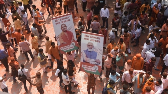 Bharatiya Janata Party (BJP) workers dance and celebrate with saffron-coloured gulal.(HT Photo/Deepak Gupta)