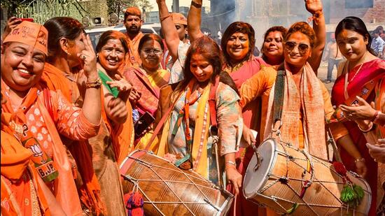 BJP supporters celebrate after party's victory in the Uttar Pradesh assembly elections, in Varanasi on Thursday. (PTI)