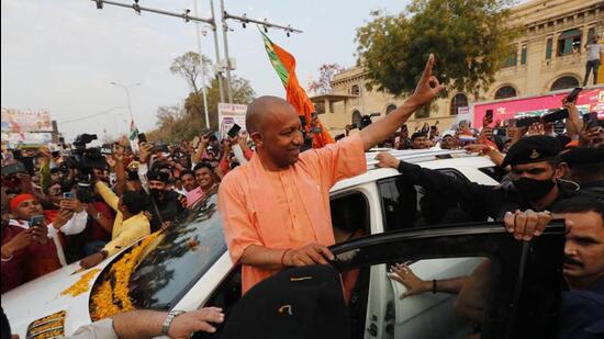 Uttar Pradesh chief minister Yogi Adityanath gestures to supporters as he arrives at the BJP office in Lucknow on Thursday. (AP PHOTO)