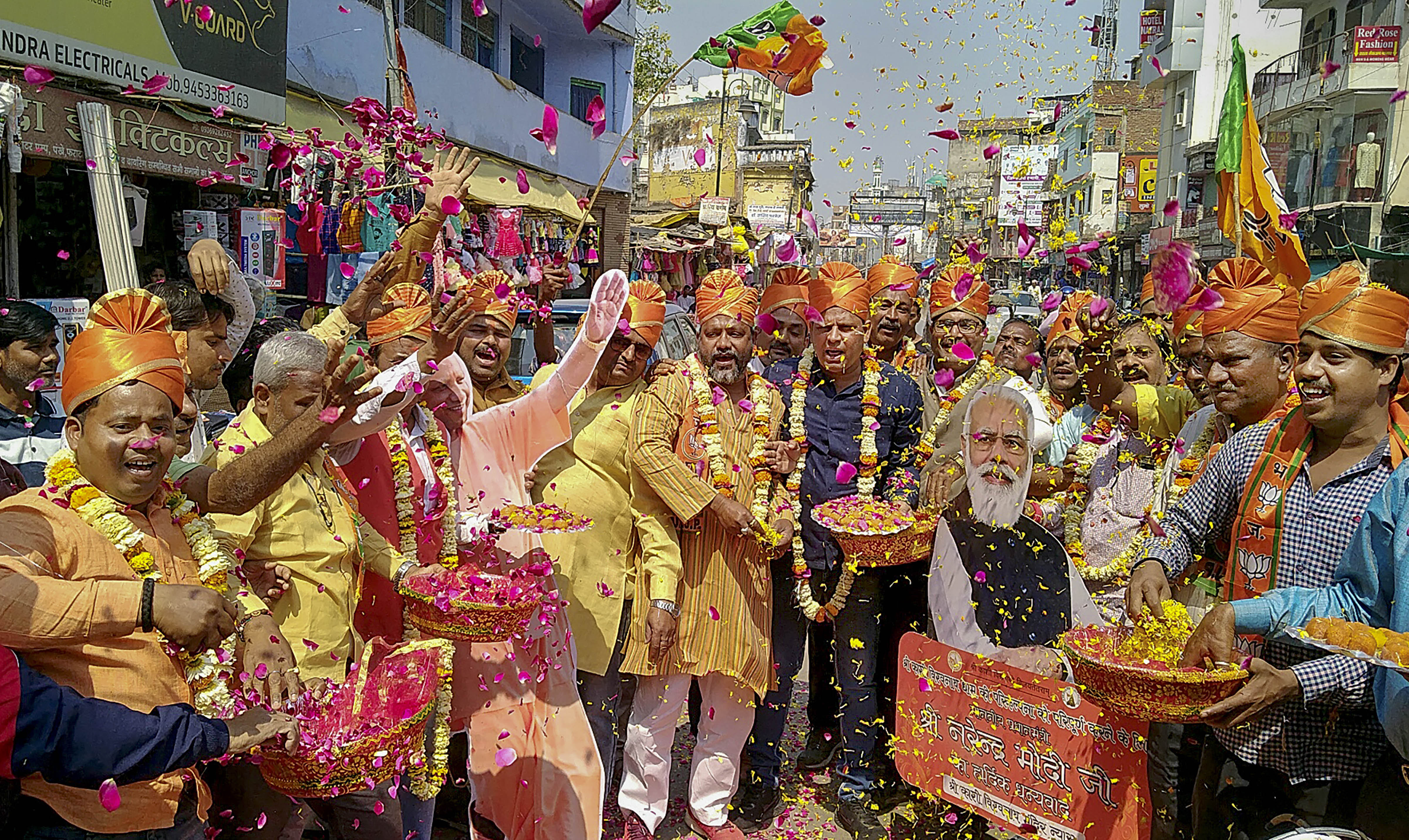 BJP supporters celebrate with flowers, as the party heads to a landslide victory in the UP Assembly elections, in Varanasi on March 10, 2022. (PTI) BJP supporters celebrate with flowers, as the party heads to a landslide victory in the UP Assembly elections, in Varanasi on March 10, 2022. (PTI)