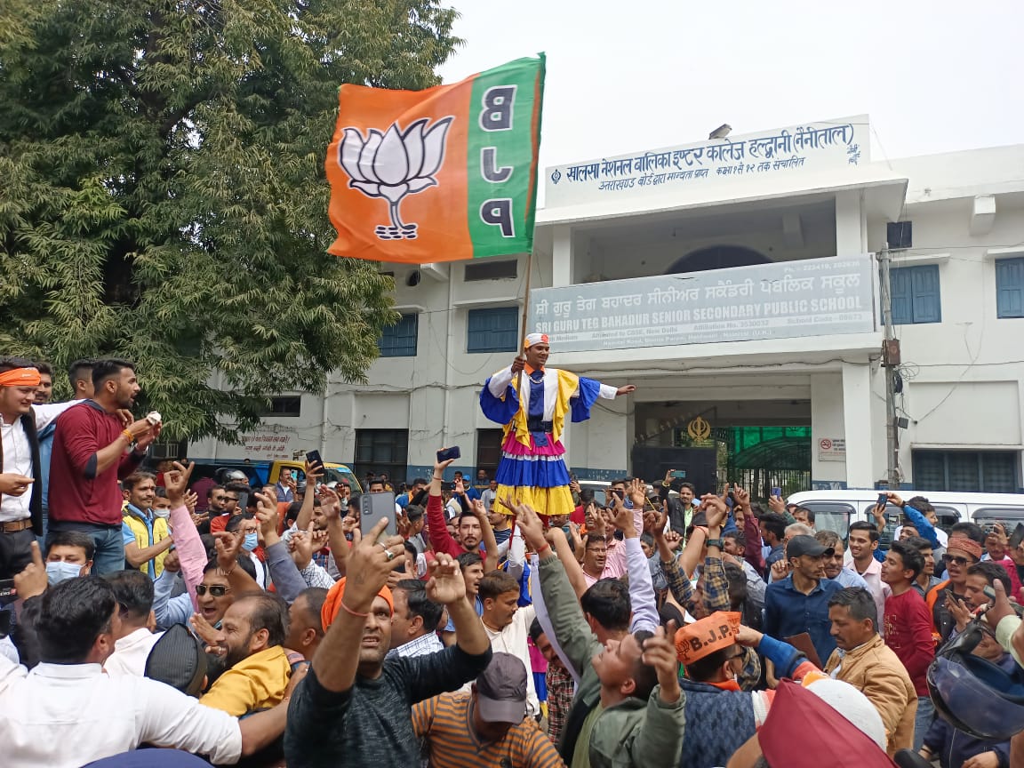 BJP workers celebrating outside party office in Uttarakhand.