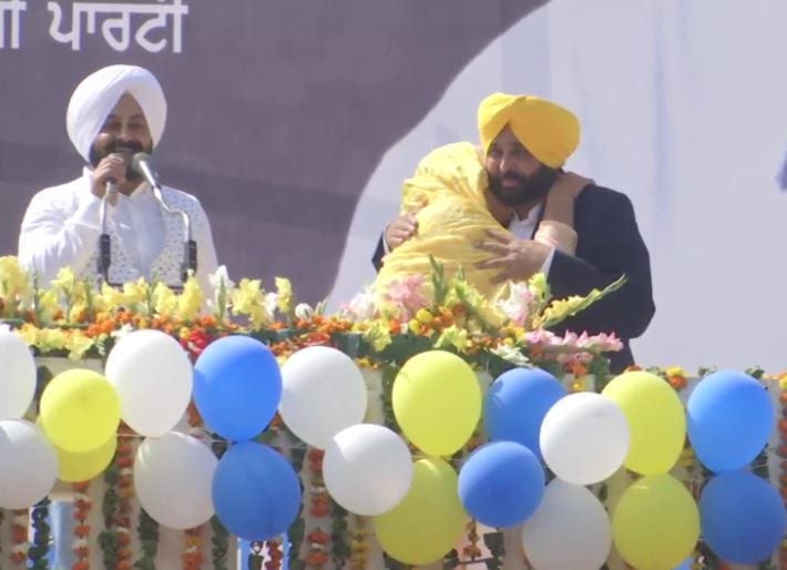 Punjab CM to-be Bhagwant Mann greets party workers outside his residence.