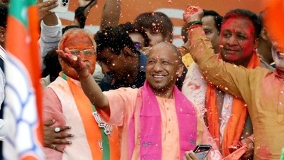 Uttar Pradesh chief minister Yogi Aditynath celebrates with party workers in Lucknow after winning the state elections on Thursday. (ANI Photo) (HT_PRINT)