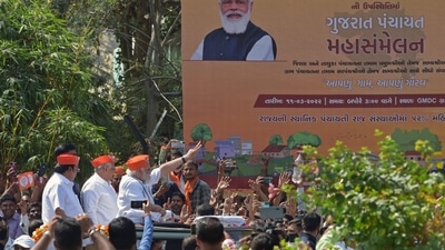 Gujarat Chief Minister Bhupendra Patel and state BJP president C R Paatil were also seen in the vehicle flanking PM Modi. (AFP) Gujarat Chief Minister Bhupendra Patel and state BJP president C R Paatil were also seen in the vehicle flanking PM Modi. (AFP)