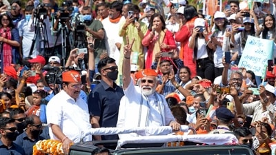 In the visuals, PM Modi can be seen riding in an open car decorated with floral garlands. (AFP) In the visuals, PM Modi can be seen riding in an open car decorated with floral garlands. (AFP)