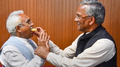 Dehradun: Former Uttarakhand chief minister Trivendra Singh Rawat feeds sweets to BJP State President Madan Kaushik after his victory in the Assembly polls from Haridwar constituency, at the party office, in Dehradun. (PTI) Dehradun: Former Uttarakhand chief minister Trivendra Singh Rawat feeds sweets to BJP State President Madan Kaushik after his victory in the Assembly polls from Haridwar constituency, at the party office, in Dehradun. (PTI)