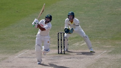 Pakistan's Imam-ul-Haq plays a shot while Australia's Alex Carey watches during the 5th day of the first Test match between Pakistan and Australia at the Pindi Stadium, in Rawalpindi, Pakistan. (AP)