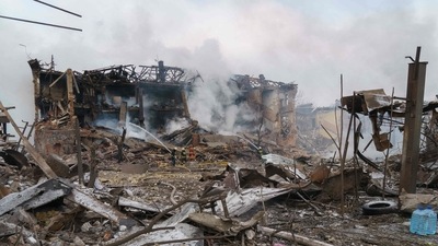 Firefighters spray water on a destroyed shoe factory following an airstrike in Dnipro. (AFP)