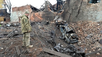 A Ukrainian serviceman looks at destructions following a shelling in Ukraine's second-biggest city of Kharkiv. (AFP) A Ukrainian serviceman looks at destructions following a shelling in Ukraine's second-biggest city of Kharkiv. (AFP)