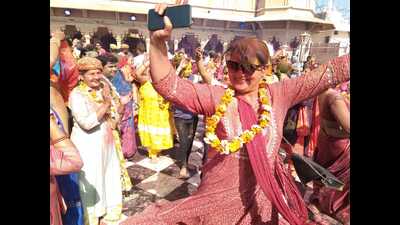 Devotees dancing to celebrate Laddoo Holi at Radha Rani Temple in Barsana. (HT)