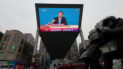 A rider drives past a giant screen showing a news conference by Chinese Premier Li Keqiang, following the closing session of the National People's Congress (NPC) at the Great Hall of the People in Beijing, China. (REUTERS) A rider drives past a giant screen showing a news conference by Chinese Premier Li Keqiang, following the closing session of the National People's Congress (NPC) at the Great Hall of the People in Beijing, China. (REUTERS)
