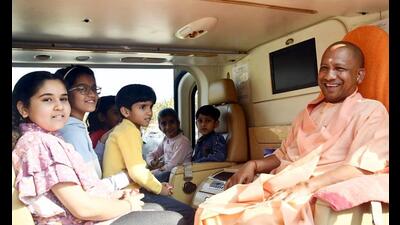 Yogi Adityanath in a helicopter with children, in Gorakhpur on Wednesday . (ANI Photo) Yogi Adityanath in a helicopter with children, in Gorakhpur on Wednesday . (ANI Photo)