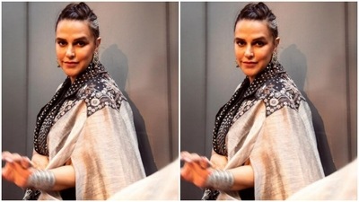 Neha's co-ord set came in a combination of a black dress layered with a dramatic shrug. Neha's shrug came detailed in silver polka dotted collars, grey sleeves and detailed embroidery in floral patterns adorning the shoulders. (Instagram/@nehadhupia)