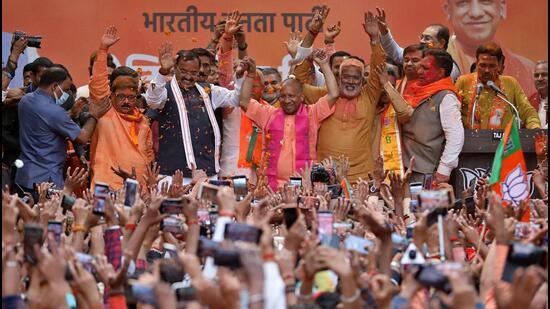 Yogi Adityanath, Uttar Pradesh chief minister designate, celebrates with his party members and supporters at the party office in Lucknow. (REUTERS PHOTO.)