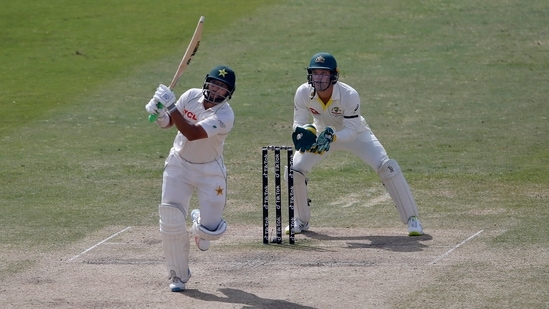 Pakistan's Imam-ul-Haq plays a shot while Australia's Alex Carey watches during the 5th day of the first Test match between Pakistan and Australia at the Pindi Stadium, in Rawalpindi, Pakistan. (AP)