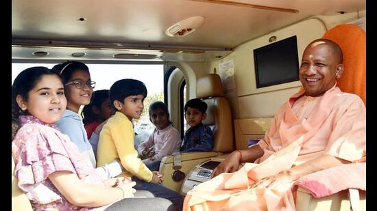 Yogi Adityanath in a helicopter with children, in Gorakhpur on Wednesday . (ANI Photo)
