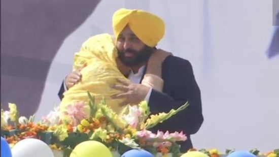 AAP's Punjab chief ministerial candidate Bhagwant Mann hugs his mother Harpal Kaur after his party won the assembly elections in the border state on Thusrday, March 10, 2022. Former cricketer Harbhajan Singh tweeted the photo to congratulate Mann. (Harbhajan Singh/Twitter)