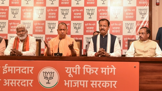 UP chief minister Yogi Adityanath speaks as BJP state chief Swatantra Dev Singh (L) and deputy CMs K P Maurya (R) and Dinesh Sharma looks on, during a press conference.(PTI)