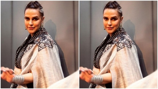 Neha's co-ord set came in a combination of a black dress layered with a dramatic shrug. Neha's shrug came detailed in silver polka dotted collars, grey sleeves and detailed embroidery in floral patterns adorning the shoulders.(Instagram/@nehadhupia)