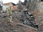 A Ukrainian serviceman looks at destructions following a shelling in Ukraine's second-biggest city of Kharkiv.(AFP) A Ukrainian serviceman looks at destructions following a shelling in Ukraine's second-biggest city of Kharkiv.(AFP)