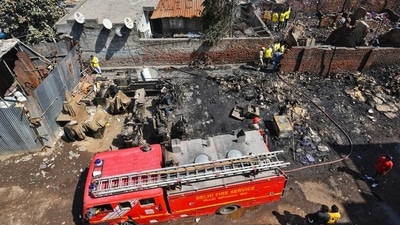 Firefighters try to douse a fire at a slum in Gokulpuri in New Delhi on Saturday. (Amal K S/HT photo)