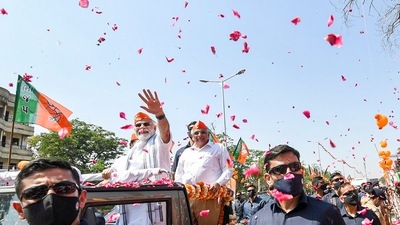 PM Modi's visit to the poll-bound state kicked off on Friday with a mega roadshow from the airport to the BJP office, Kamalam, followed by a meeting with the party leaders in Ahmedabad. (PTI)