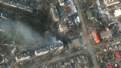 A satellite image shows burning apartment buildings at Zelinskovo street, in the western section of Mariupol, Ukraine. (via REUTERS)