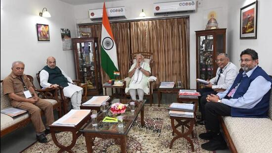 PM Modi presiding over a meeting of Shree Somnath Temple trustees on Friday at Raj Bhawan in Gandhinagar. (HT PHOTO.)