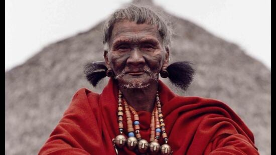 During the 25th anniversary of the founding on the Mon Church in Mon village, the village shaman dressed with his red blanket that is given by the state government to the village elders (Gaon Burra), and wearing earrings of bear hair and a bead necklace with brass heads that signify the number of heads he may have taken in his lifetime. (PABLO BARTHOLOMEW)