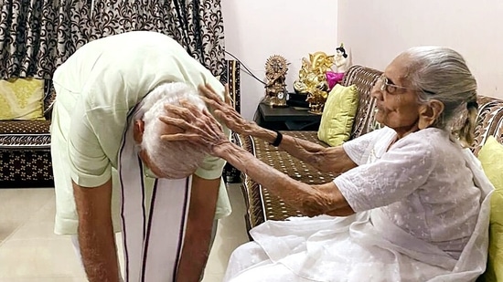 In the visuals, PM Modi can be seen taking blessings from his mother by touching her feet.(ANI)