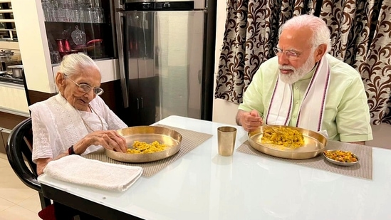 PM Modi wraps up with his commitments for the day and spends time with his mother Heeraben Modi. They sit together in their dining area and enjoy a traditional meal on copper cutleries.(PTI)