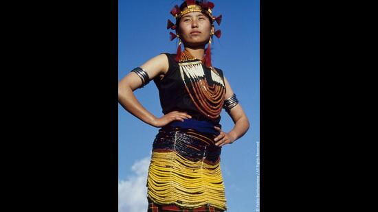 A young Sema girl in a beaded overskirt indicating her status as a member of a wealthy and influential family. Zuneboto District, Nagaland. (PABLO BARTHOLOMEW)