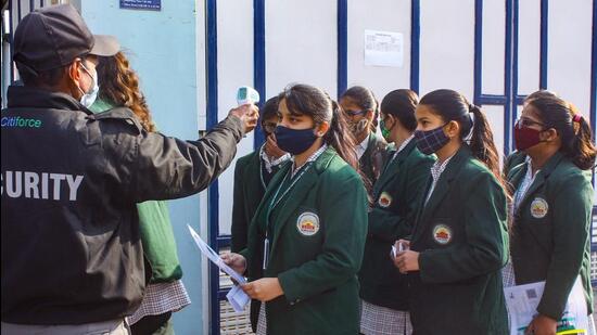 Student undergo thermal screening before entering an examination centre to appear for the CBSE's Term 1 Class 12 board exams on December 21, 2021. (PTI)