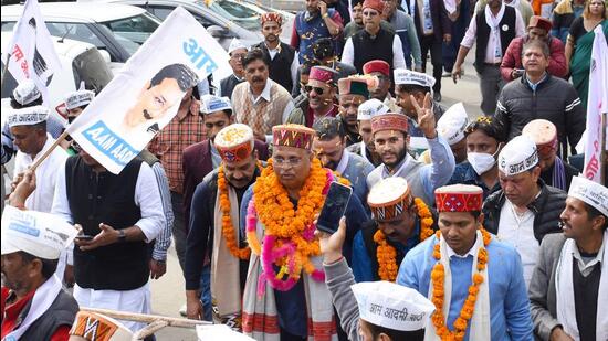 Aam Aadmi Party leader and Delhi health minister Satyendar Jain marches with party workers during a victory rally in Shimla on Saturday. (Deepak Sansta/Hindustan Times)