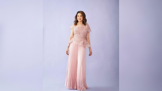 The top is made of sheer material and has shimmery silver and rose gold patterns all over.(Instagram/@madhuridixitnene)