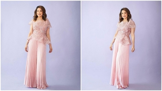 Madhuri Dixit is like a fairy in disguise who quietly casts a spell on her fans and leaves them mesmerised with her beauty and elegance. The Hum Aaoke Hain Kaun actor has more than 30 million followers and she makes sure to often treat them with beautiful pictures of herself in stunning designer fits. In her recent photoshoot stills, the actor can be seen posing in a mesh top and pleated pants set by designer Tanieya Khanuja.(Instagram/@madhuridixitnene)