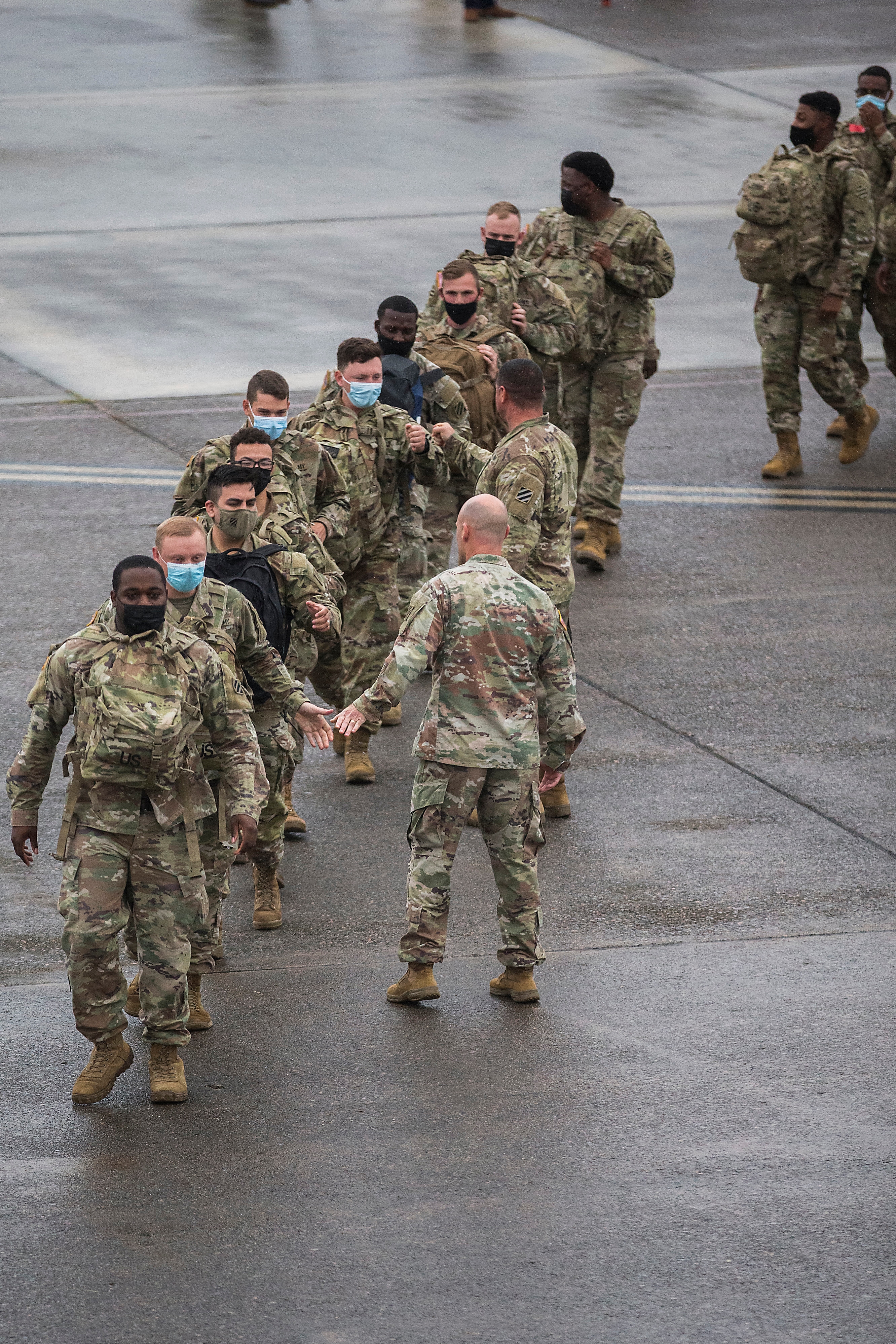 US soldiers walk to a chartered plane during their deployment to Europe. The unit will join the 3,800 troops, already deployed in support of NATO in Eastern Europe. (AP) US soldiers walk to a chartered plane during their deployment to Europe. The unit will join the 3,800 troops, already deployed in support of NATO in Eastern Europe. (AP)