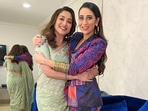 Madhuri Dixit held Karisma Kapoor in a new picture.