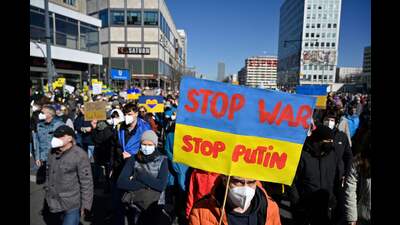 A protester holds up a poster in the colours of Ukraine, Berlin, March 13, 2022 (AFP) A protester holds up a poster in the colours of Ukraine, Berlin, March 13, 2022 (AFP)