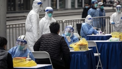 Health workers tests for Covid outside of a clothing market in Shanghai, China. (Bloomberg) Health workers tests for Covid outside of a clothing market in Shanghai, China. (Bloomberg)