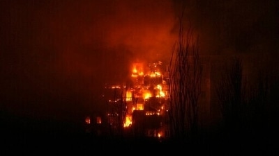 A fire burns at an apartment building after it was hit by the shelling of a residential district in Mariupol. (AP)