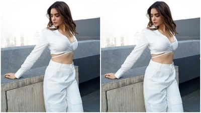 Aamna paired a full-sleeved cropped stain shirt with a pair of white cargo trousers. In beach wavy curls, Aamna looked picture-perfect. (Instagram/@aamnasharifofficial)